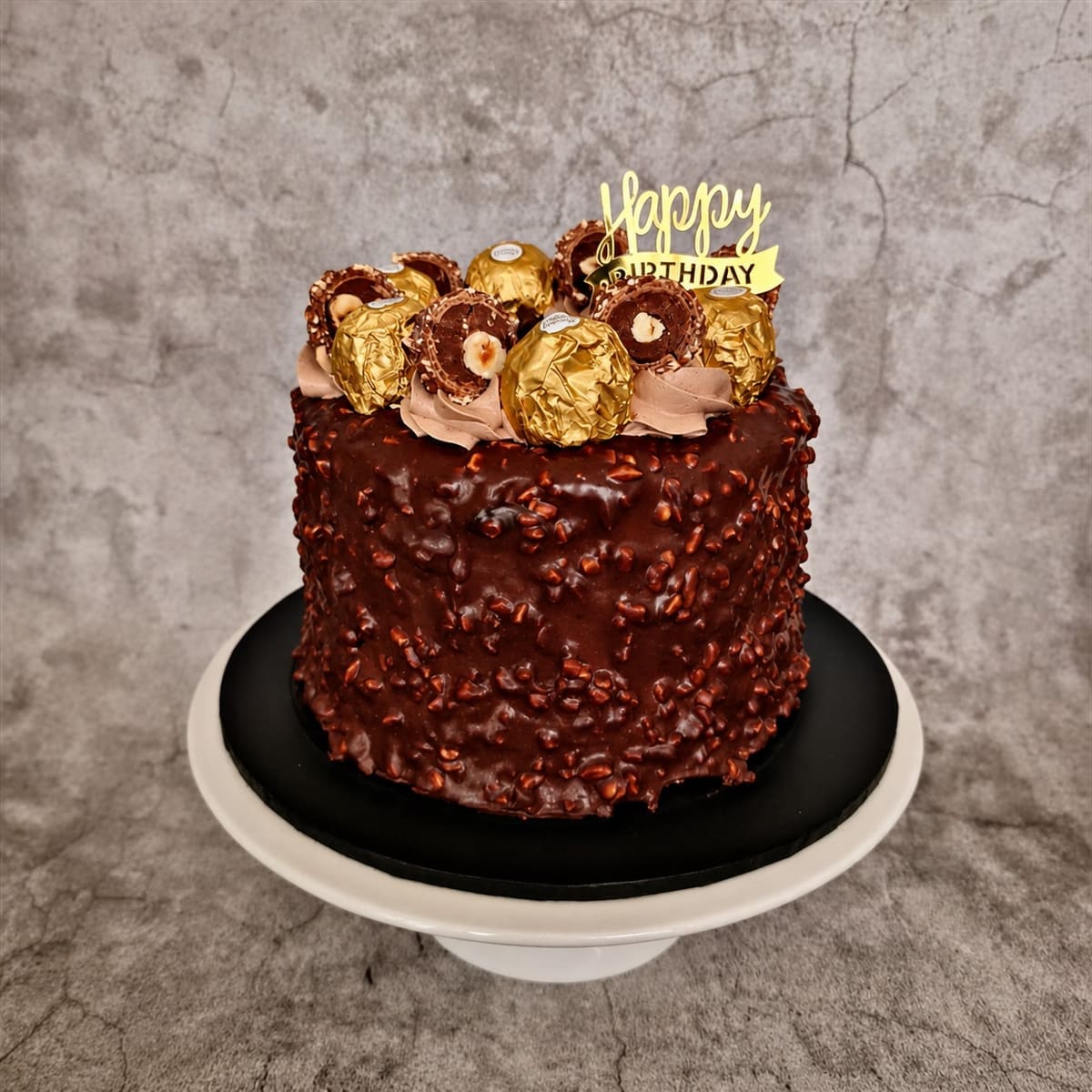 Chocolate hazelnut birthday cake with piped decoration