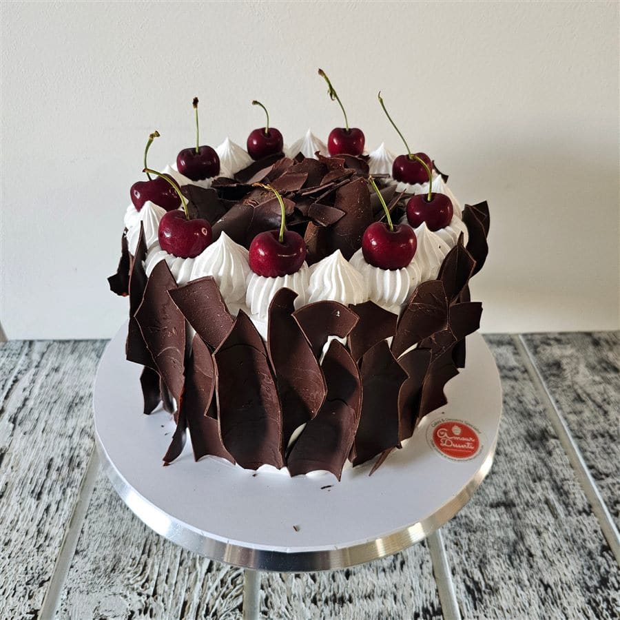 Black forest birthday cake with cherries and cream